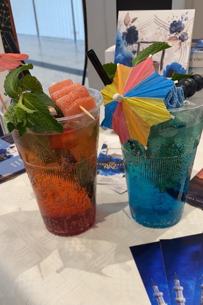 Zwei Mocktails werden gezeigt: ein Erdbeer- und ein Heidelbeermocktail mit Schirmchen, Minze, Heidelbeeren und Fruchtgummibändern